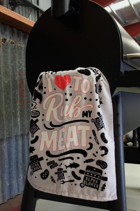 Towel with text and graphics hanging on a black stand