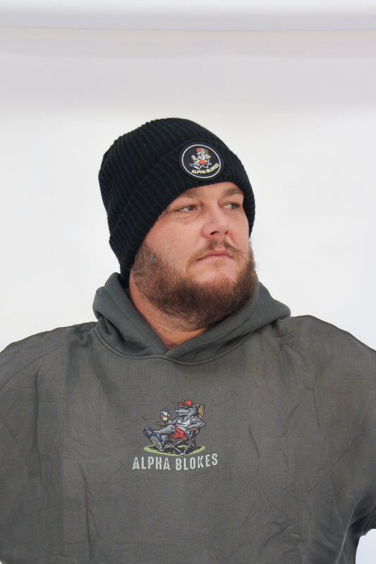 Man wearing a black beanie and gray hoodie with 'Alpha Blokes' logo on a white background