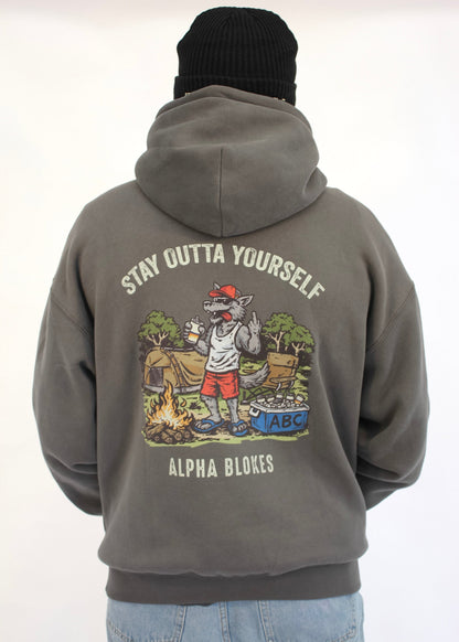 Person wearing a gray hoodie with a graphic design on the back, featuring text and illustrations.